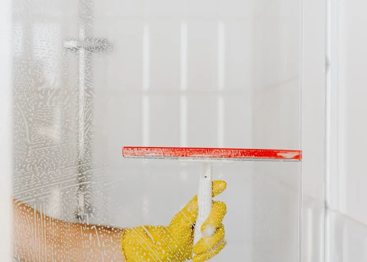 cleaning shower doors with squeegee
