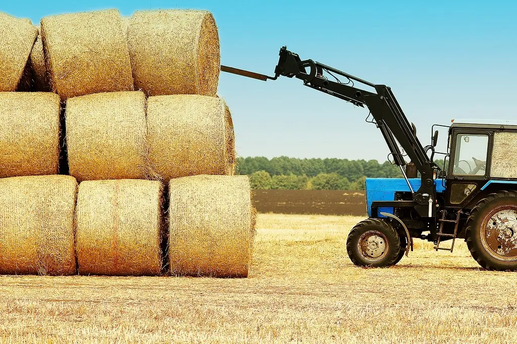 tractor storing hay bale